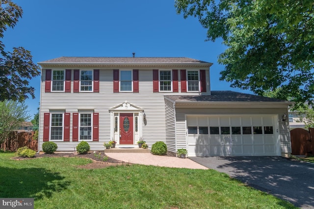 colonial home with driveway and an attached garage