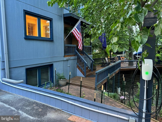 view of home's exterior featuring stairway and a wooden deck