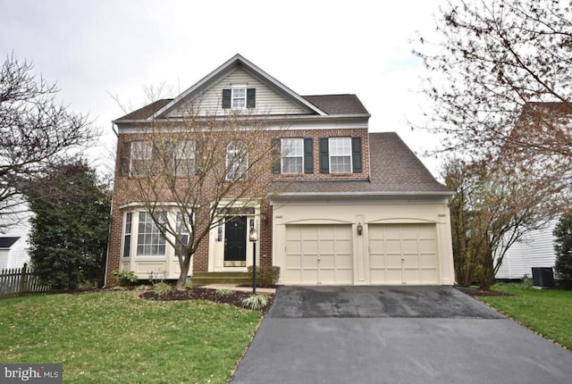 view of front of house featuring asphalt driveway and brick siding