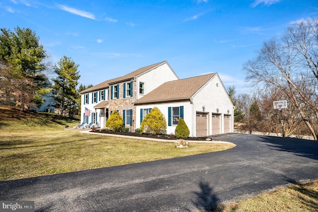 5 Craig Ln, Malvern, PA 19355 - colonial home with a front lawn, driveway, a garage, and stucco siding