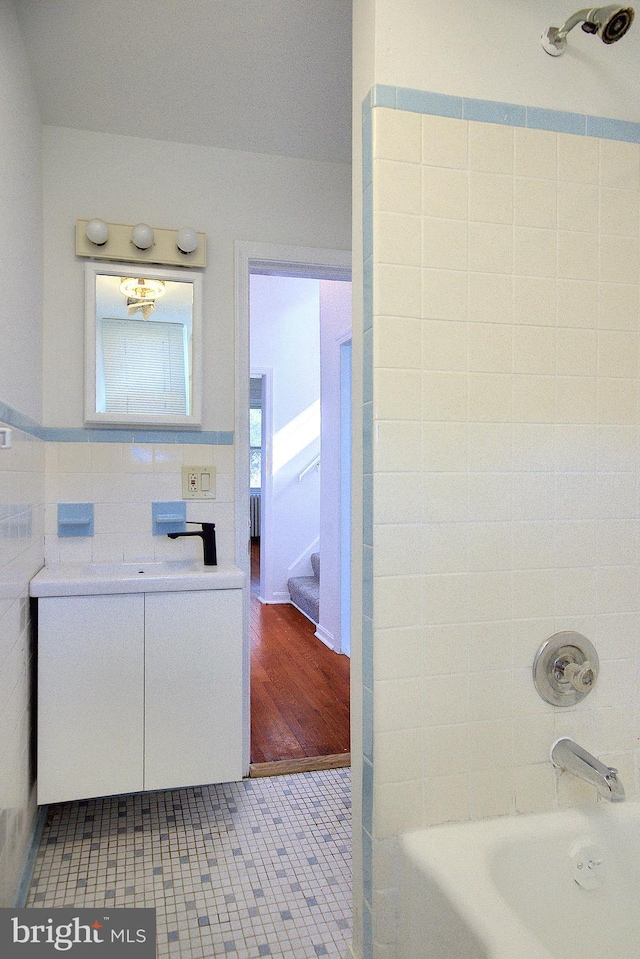2530 18th St N, Arlington, VA 22201 - bathroom with vanity, shower / bathtub combination, tile walls, and tile patterned floors