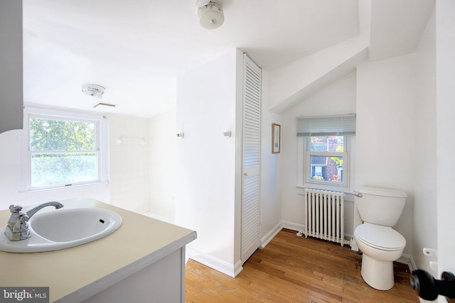 2530 18th St N, Arlington, VA 22201 - bathroom with radiator, wood finished floors, toilet, vanity, and baseboards