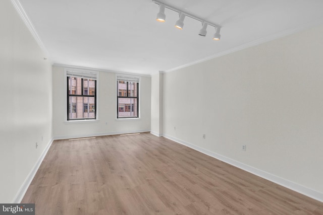 631 D St NW Unit 431, Washington, DC 20004 - empty room featuring ornamental molding, light wood-style flooring, rail lighting, and baseboards
