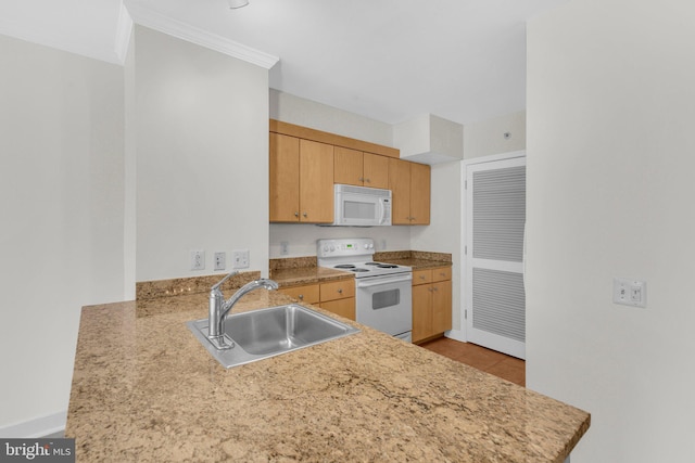 631 D St NW Unit 431, Washington, DC 20004 - kitchen with white appliances, a sink, light countertops, light tile patterned floors, and a peninsula
