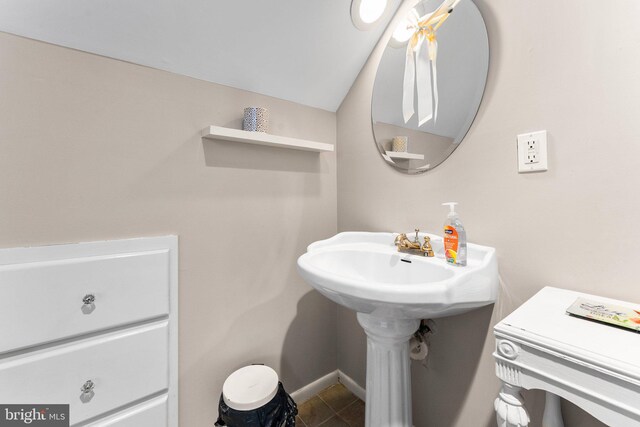 105 Bayview Ln, Hague, VA 22469 - half bathroom featuring tile patterned flooring, baseboards, and vaulted ceiling