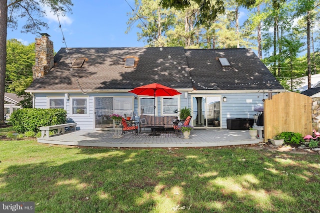 105 Bayview Ln, Hague, VA 22469 - back of property featuring a chimney, a deck, a yard, roof with shingles, and an outdoor living space