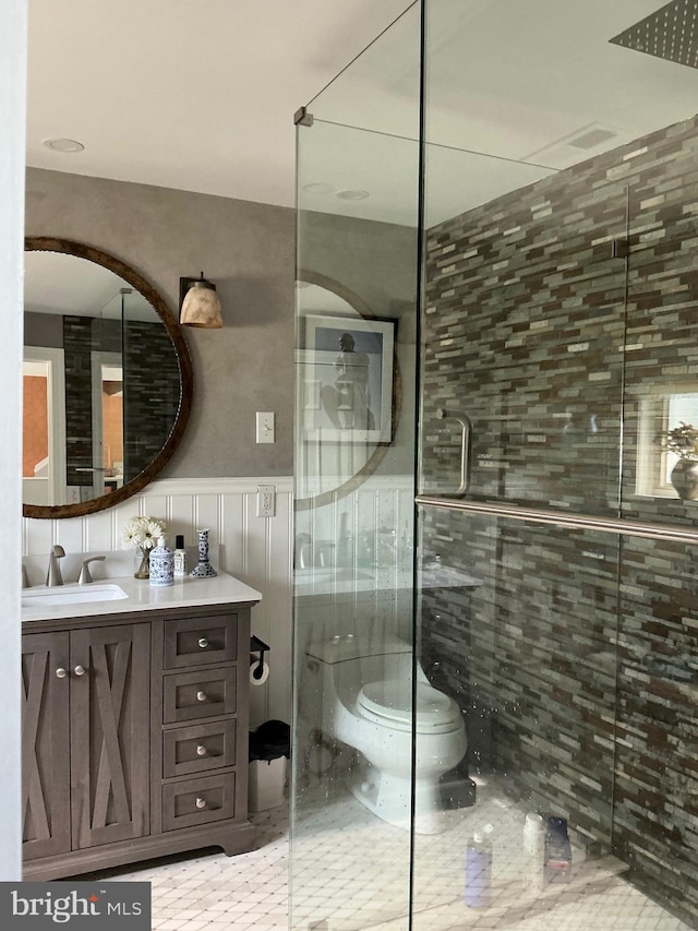 105 Bayview Ln, Hague, VA 22469 - bathroom with toilet, vanity, a shower stall, and wainscoting