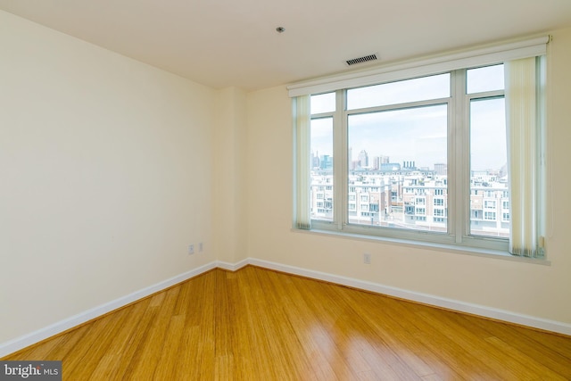 100 Harborview Dr Unit 513, Baltimore, MD 21230 - empty room with wood finished floors, baseboards, healthy amount of natural light, and a view of city