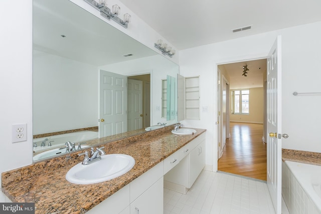 100 Harborview Dr Unit 513, Baltimore, MD 21230 - bathroom featuring a garden tub, tile patterned flooring, and double vanity