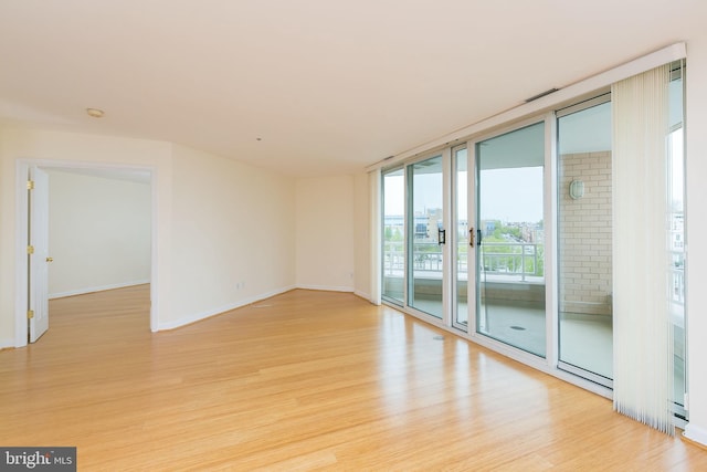 100 Harborview Dr Unit 513, Baltimore, MD 21230 - unfurnished room featuring light wood-style flooring, baseboards, and floor to ceiling windows