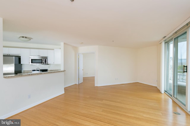 100 Harborview Dr Unit 513, Baltimore, MD 21230 - unfurnished living room with light wood-style floors and baseboards
