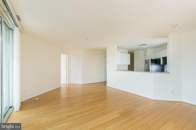 100 Harborview Dr Unit 513, Baltimore, MD 21230 - unfurnished living room with light wood-type flooring and baseboards