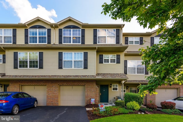 261 Osprey Ln, Hummelstown, PA 17036 - view of property with driveway, a garage, and brick siding