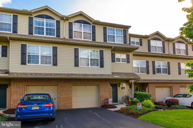 261 Osprey Ln, Hummelstown, PA 17036 - multi unit property with driveway, an attached garage, and brick siding
