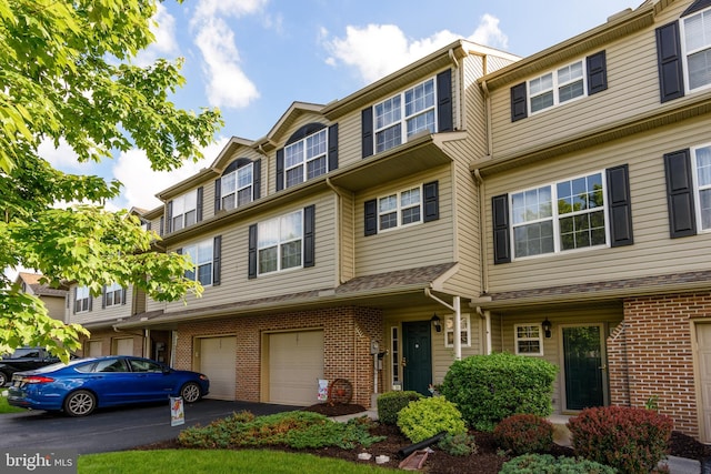 261 Osprey Ln, Hummelstown, PA 17036 - townhome / multi-family property featuring brick siding, driveway, and a garage