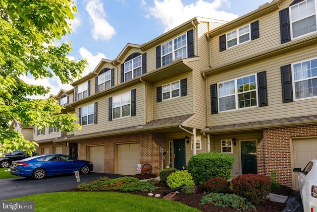 261 Osprey Ln, Hummelstown, PA 17036 - view of property with brick siding, an attached garage, and driveway