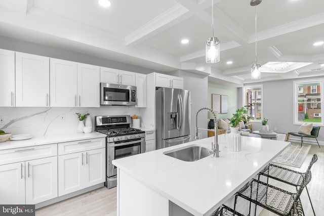 1505 N Pulaski St, Baltimore, MD 21217 - kitchen featuring stainless steel appliances, a sink, light wood-style floors, recessed lighting, and a kitchen breakfast bar