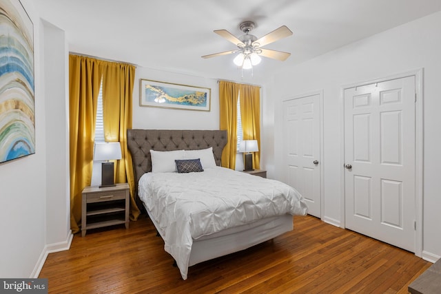 bedroom featuring wood-type flooring, ceiling fan, and baseboards