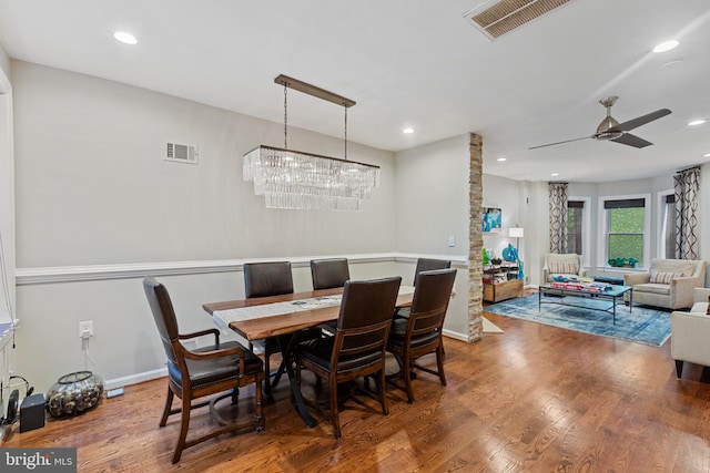 dining room featuring wood finished floors, ceiling fan, a chandelier, and recessed lighting