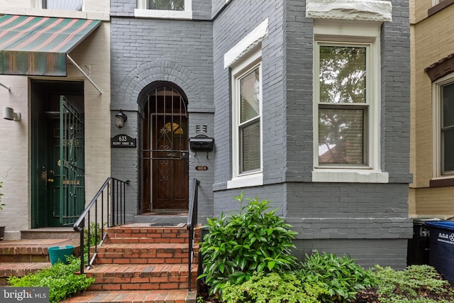 entrance to property with brick siding