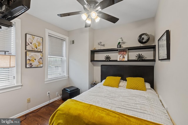 bedroom featuring wood finished floors, baseboards, and a ceiling fan