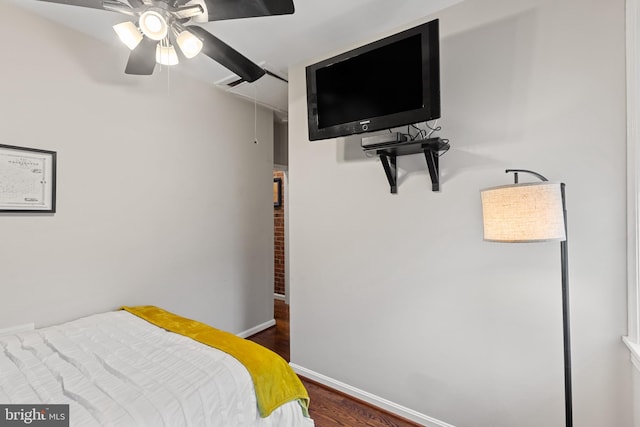 bedroom featuring wood finished floors, baseboards, and ceiling fan