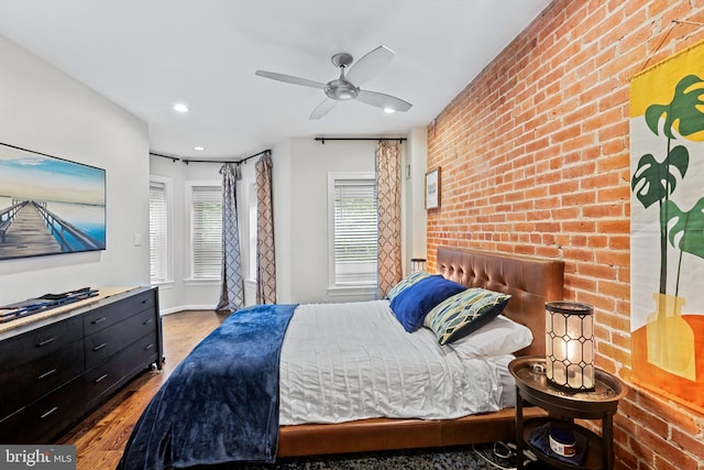 bedroom with wood finished floors, brick wall, ceiling fan, and recessed lighting