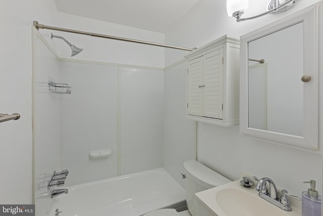 bathroom with toilet, shower / bathtub combination, and a sink