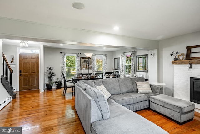 40 Hunters Run Rd, Honey Brook, PA 19344 - living area featuring light wood-style flooring, stairs, a fireplace, a baseboard radiator, and recessed lighting