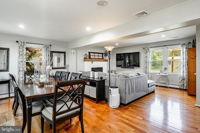 40 Hunters Run Rd, Honey Brook, PA 19344 - dining room featuring a fireplace, a baseboard heating unit, light wood finished floors, and recessed lighting