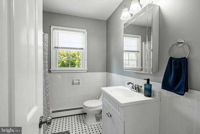 40 Hunters Run Rd, Honey Brook, PA 19344 - full bath featuring a baseboard heating unit, tile walls, toilet, tile patterned flooring, and a wainscoted wall