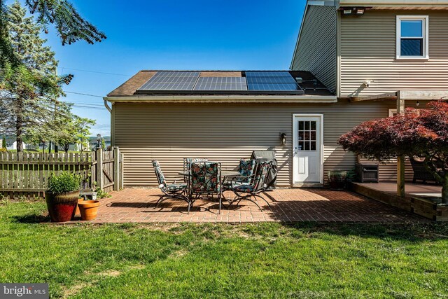 40 Hunters Run Rd, Honey Brook, PA 19344 - rear view of property featuring solar panels, a patio area, and a shingled roof