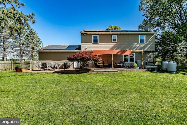 40 Hunters Run Rd, Honey Brook, PA 19344 - rear view of house featuring a patio, roof mounted solar panels, and a chimney