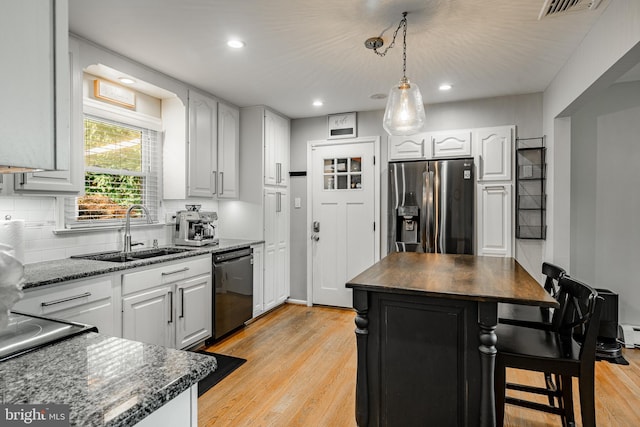 40 Hunters Run Rd, Honey Brook, PA 19344 - kitchen featuring stainless steel fridge, black dishwasher, a sink, light wood-type flooring, and backsplash