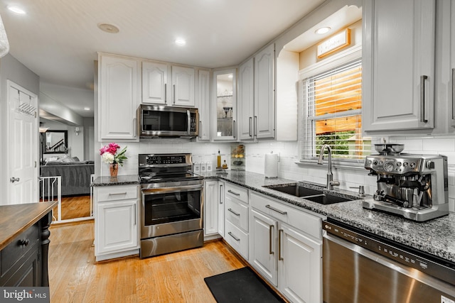 40 Hunters Run Rd, Honey Brook, PA 19344 - kitchen with appliances with stainless steel finishes, a sink, dark stone counters, backsplash, and recessed lighting