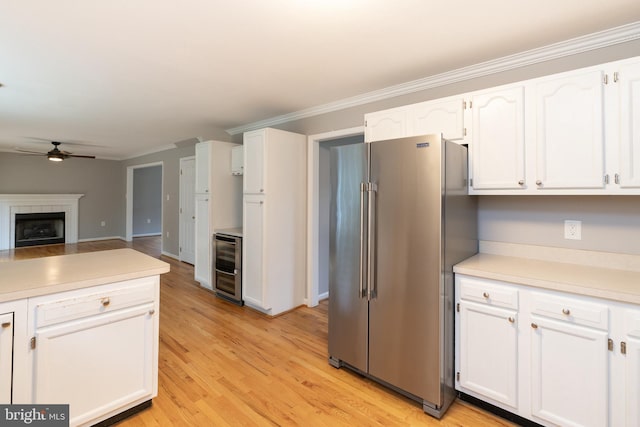 306 Canyon Rd, Winchester, VA 22602 - kitchen featuring high end fridge, ceiling fan, white cabinetry, crown molding, and light wood-style floors