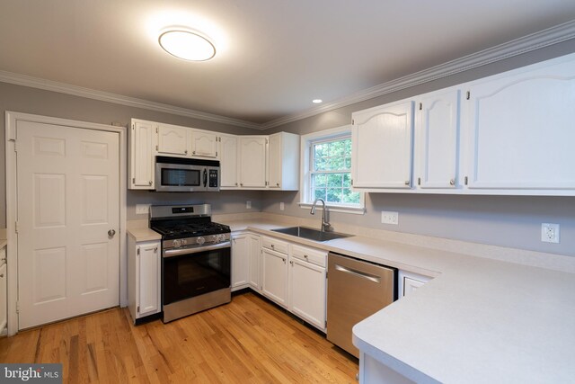 306 Canyon Rd, Winchester, VA 22602 - kitchen featuring stainless steel appliances, a sink, ornamental molding, and white cabinetry