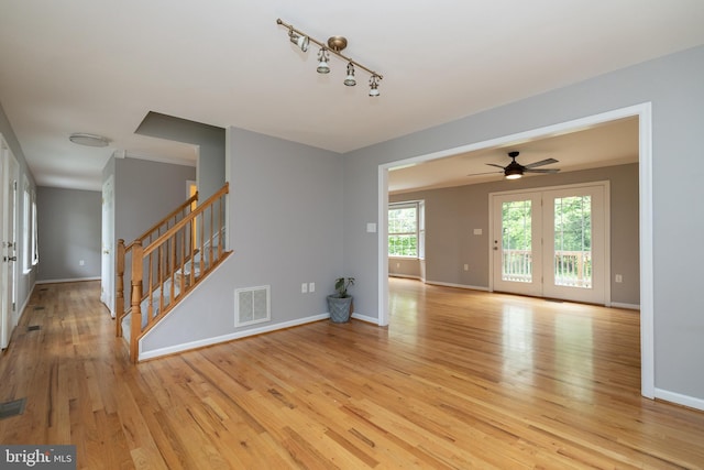 306 Canyon Rd, Winchester, VA 22602 - unfurnished living room featuring light wood-type flooring, baseboards, stairs, and a ceiling fan