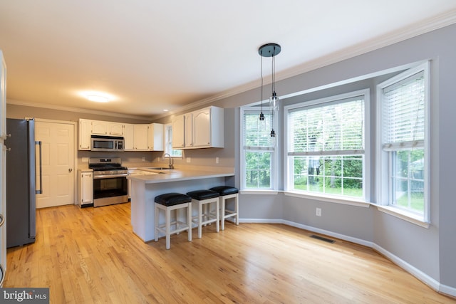 306 Canyon Rd, Winchester, VA 22602 - kitchen with appliances with stainless steel finishes, a sink, a peninsula, crown molding, and light countertops