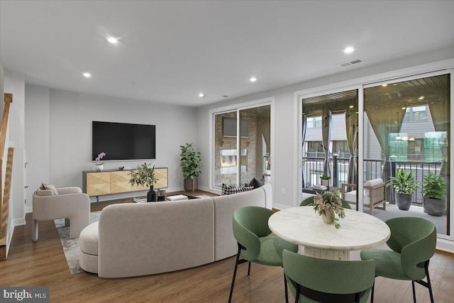 living area featuring wood finished floors, recessed lighting, and baseboards