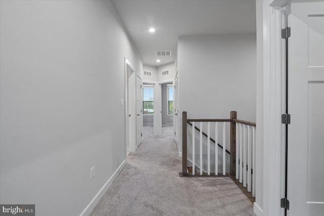 hallway with an upstairs landing, carpet flooring, recessed lighting, and baseboards