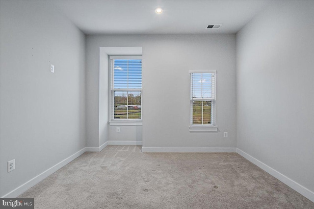 unfurnished room with carpet, plenty of natural light, baseboards, and recessed lighting