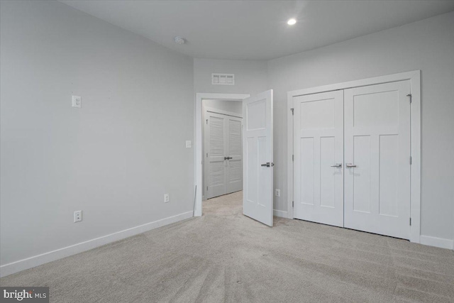 unfurnished bedroom with carpet, baseboards, a closet, and recessed lighting