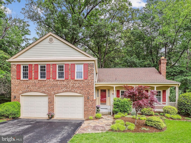 2032 Franklin Cluster Ct, Falls Church, VA 22043 - view of front of property with asphalt driveway, brick siding, a chimney, a garage, and roof with shingles