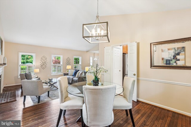 2032 Franklin Cluster Ct, Falls Church, VA 22043 - dining area with a chandelier, dark wood-style floors, baseboards, vaulted ceiling, and a fireplace