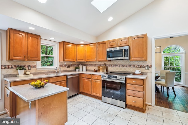 2032 Franklin Cluster Ct, Falls Church, VA 22043 - kitchen with appliances with stainless steel finishes, a sink, a skylight, vaulted ceiling, and tasteful backsplash