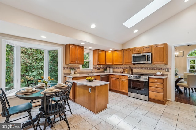 2032 Franklin Cluster Ct, Falls Church, VA 22043 - kitchen with stainless steel appliances, vaulted ceiling, a skylight, backsplash, and light countertops