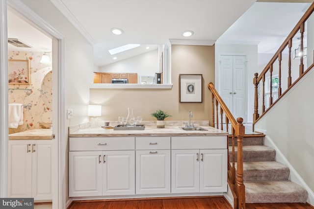 2032 Franklin Cluster Ct, Falls Church, VA 22043 - bar area featuring a sink, stairway, crown molding, wood finished floors, and stainless steel microwave