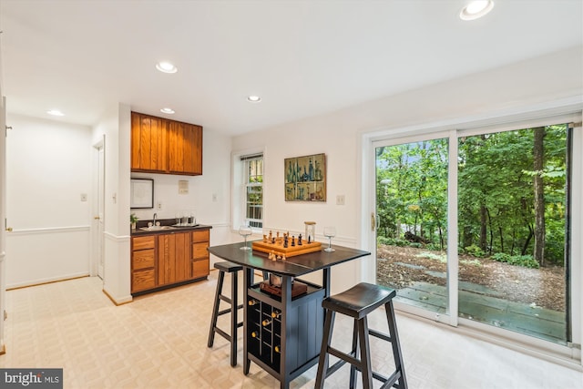 2032 Franklin Cluster Ct, Falls Church, VA 22043 - kitchen with brown cabinets, a sink, recessed lighting, dark countertops, and light floors