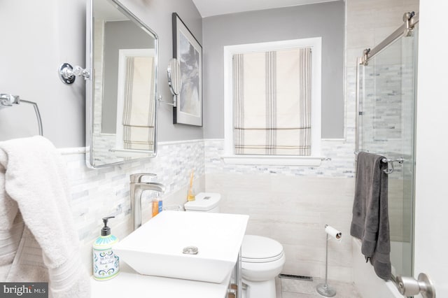 1909 Bloomingdale Ave, Lancaster, PA 17601 - bathroom with a shower stall, toilet, tile walls, a wainscoted wall, and tile patterned floors